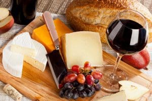 Red Wine And Assorted Cheese Plate with fruit