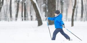 Small boy cross-country skiing in the park
